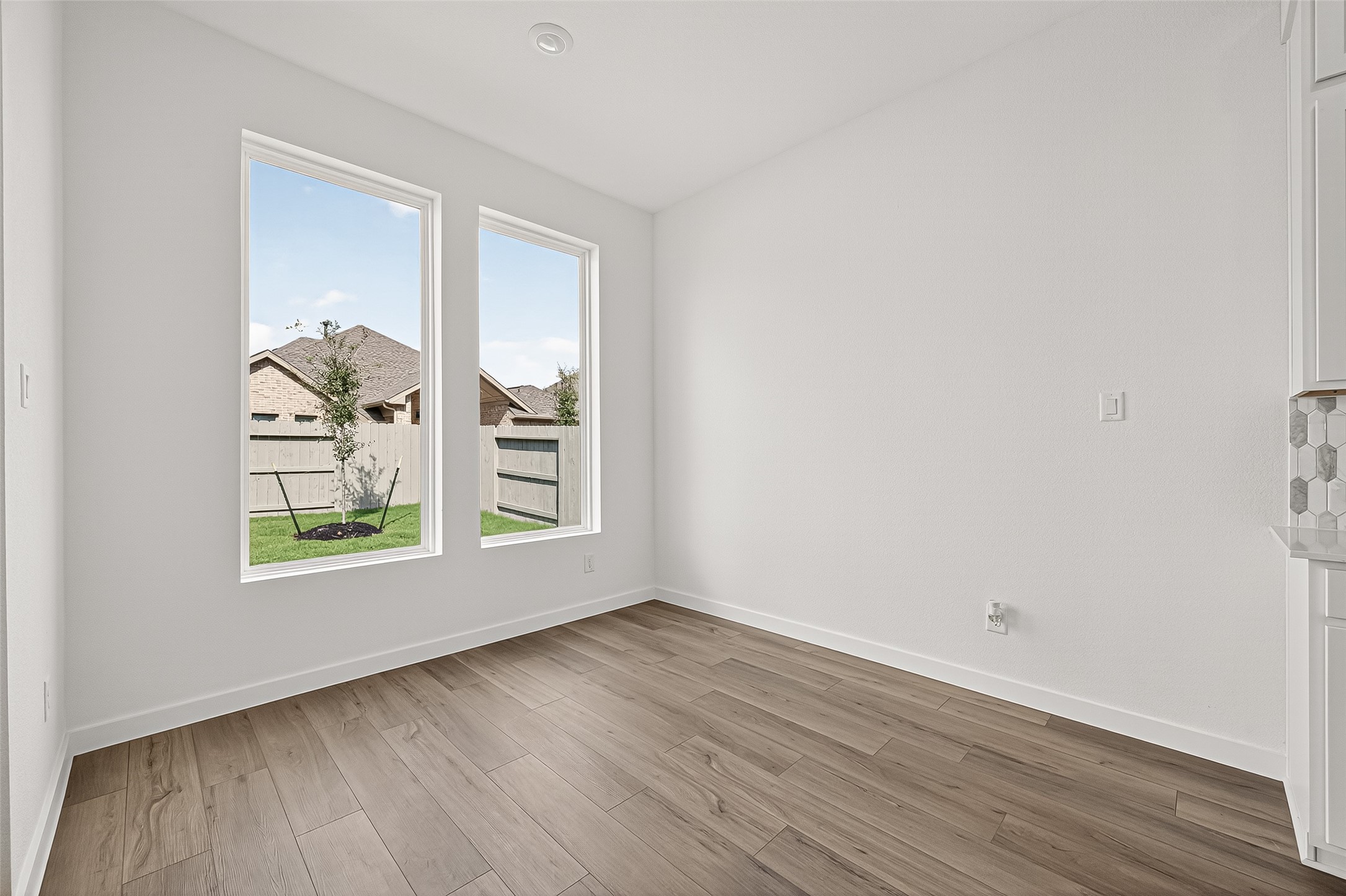 2419 Hazel Berry Street Manvel, TX 77578 - Photo 14 of 50 an empty room with wooden floor and window