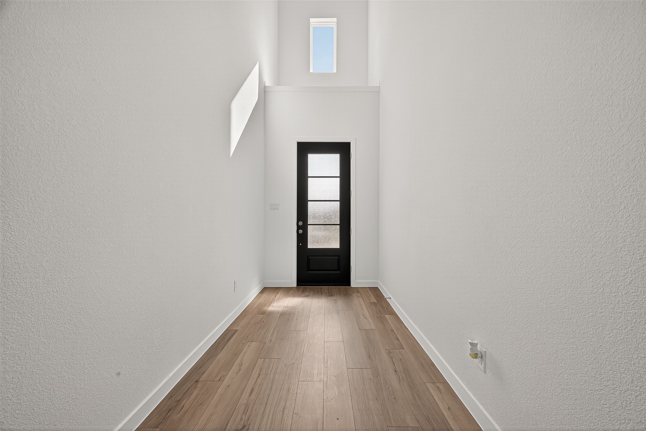 2419 Hazel Berry Street Manvel, TX 77578 - Photo 5 of 50 a view of an empty room with wooden floor and a window