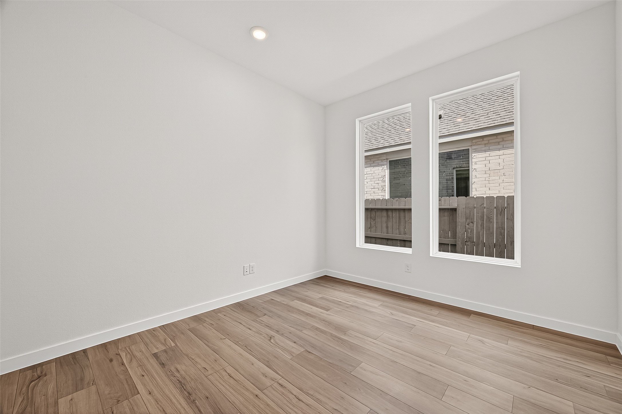 2419 Hazel Berry Street Manvel, TX 77578 - Photo 7 of 50 a view of an empty room with wooden floor and a window