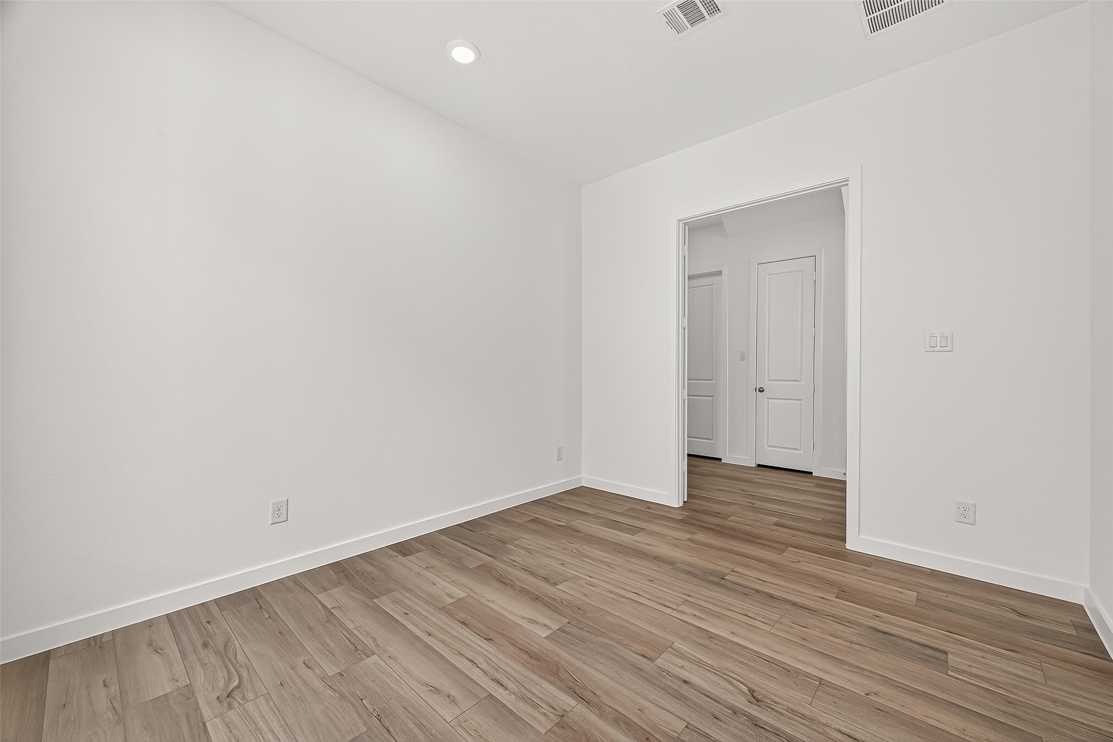 2419 Hazel Berry Street Manvel, TX 77578 - Photo 8 of 50 a view of an empty room with wooden floor and closet