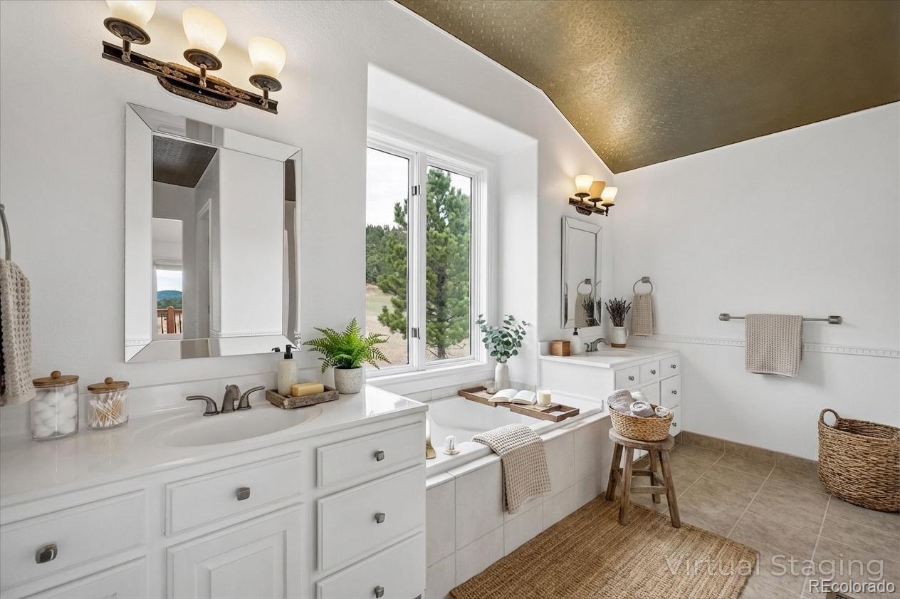 6320 Valley Lane Morrison, CO 80465 - Photo 12 of 28 a spacious bathroom with sinks mirror and a bathtub