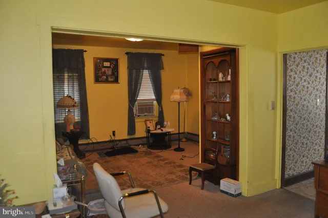 a view of a livingroom with furniture and staircase