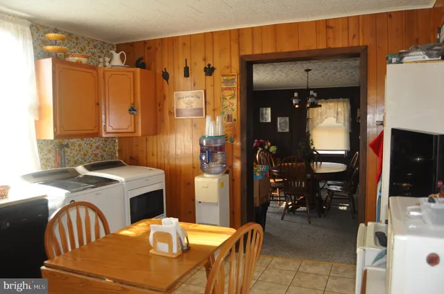 a kitchen with stainless steel appliances granite countertop a stove refrigerator and cabinets