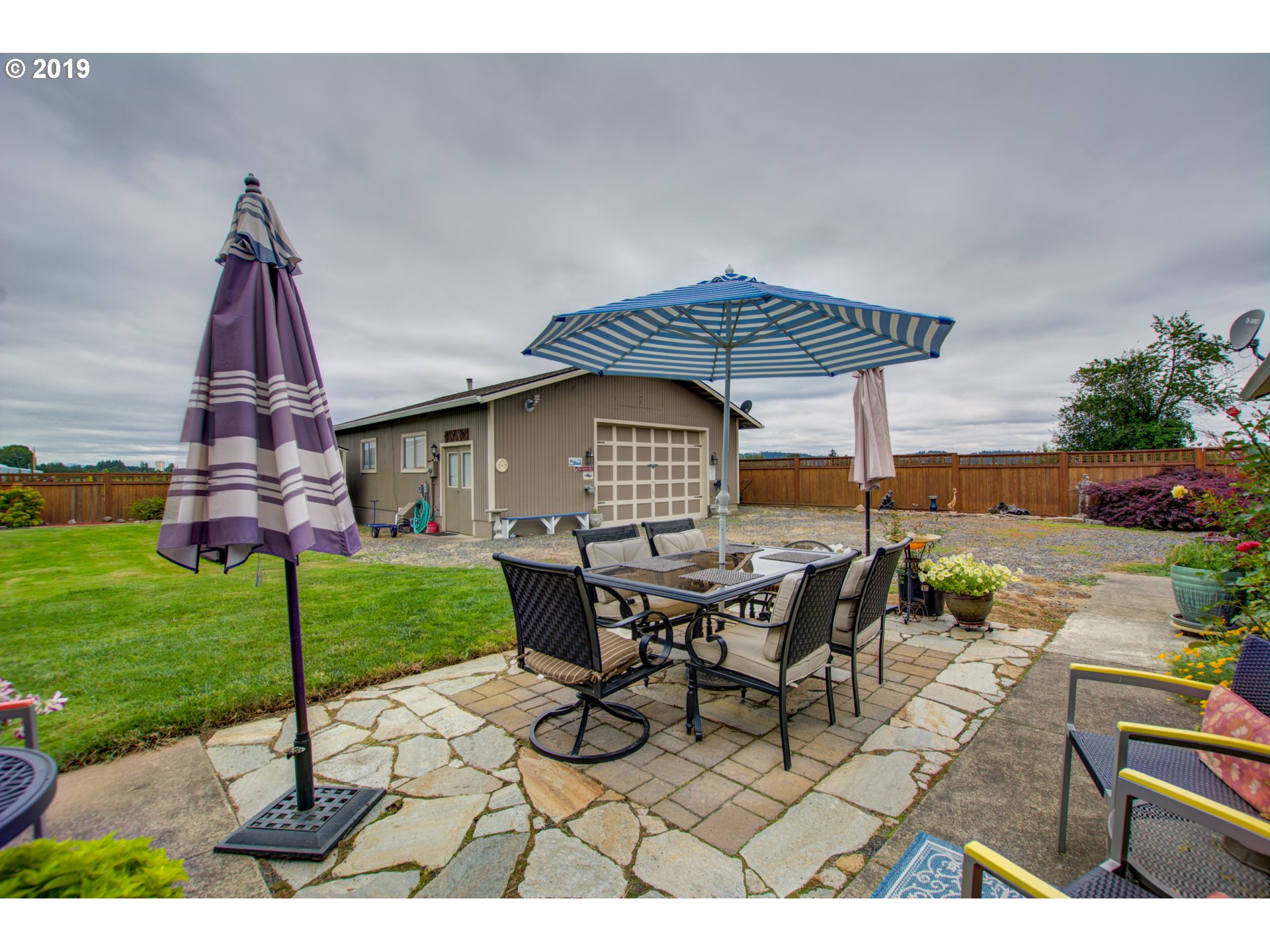 6180 Southeast Lusted Road Gresham, OR 97080 - Photo 19 of 30 a view of a patio with table and chairs under an umbrella