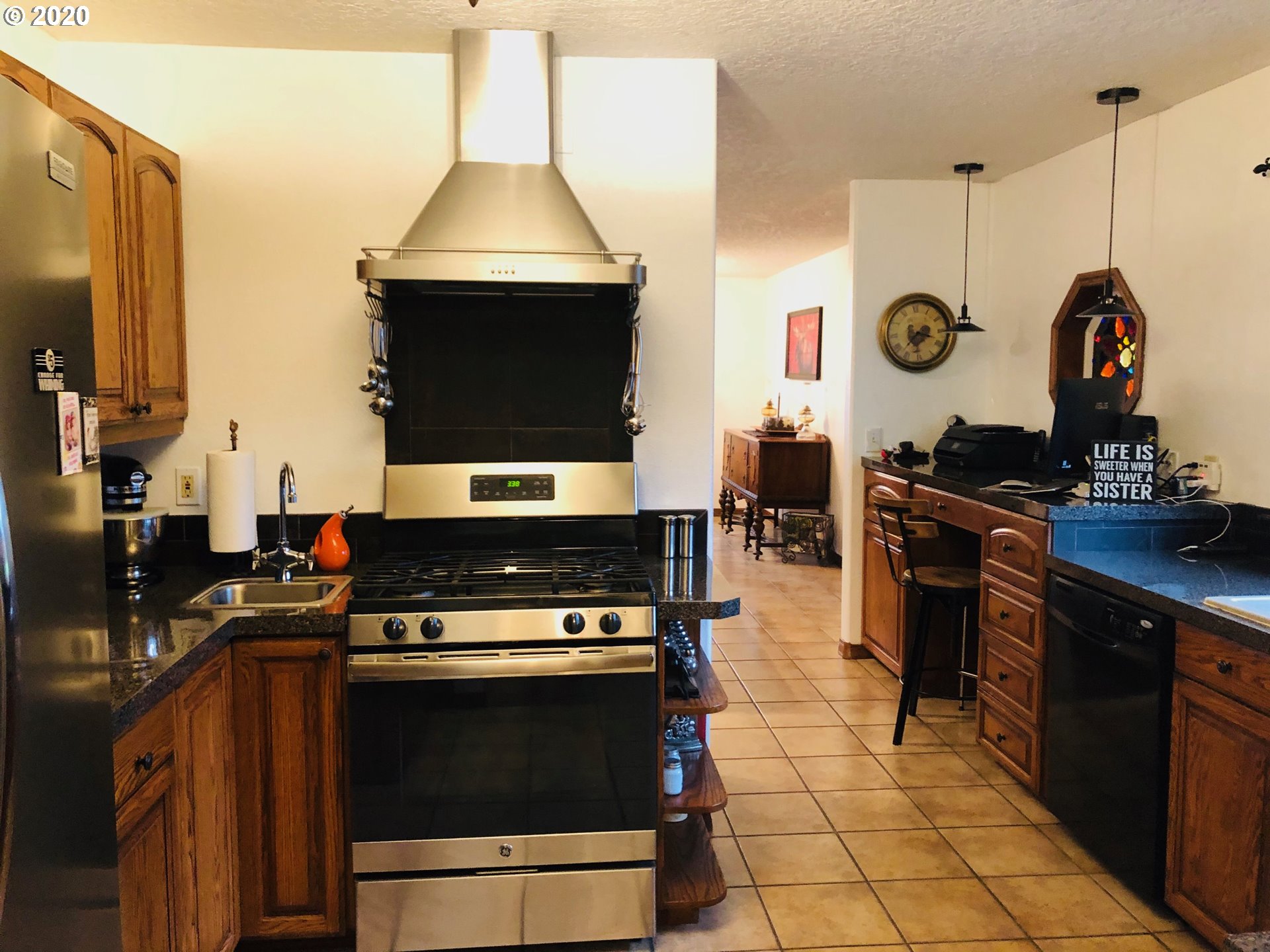 6180 Southeast Lusted Road Gresham, OR 97080 - Photo 10 of 30 a kitchen with stainless steel appliances granite countertop a stove a sink and a microwave