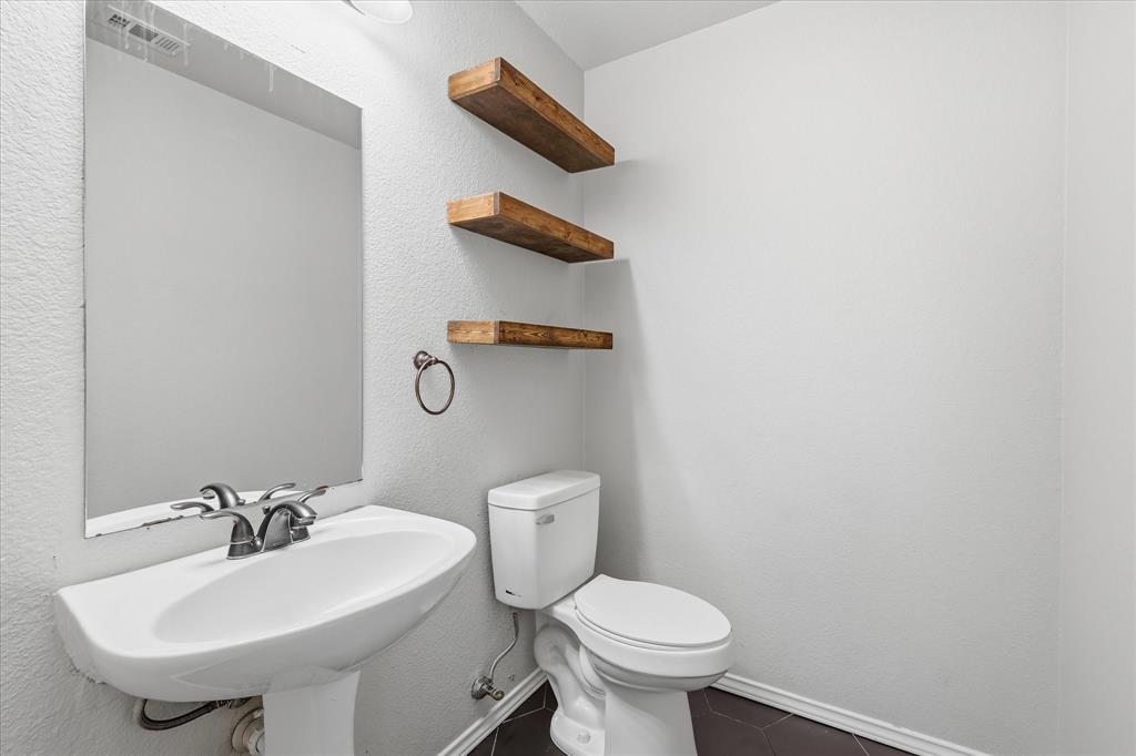 13236 Ridgepointe Road Fort Worth, TX 76244 - Photo 9 of 19 a bathroom with a sink a toilet and a mirror