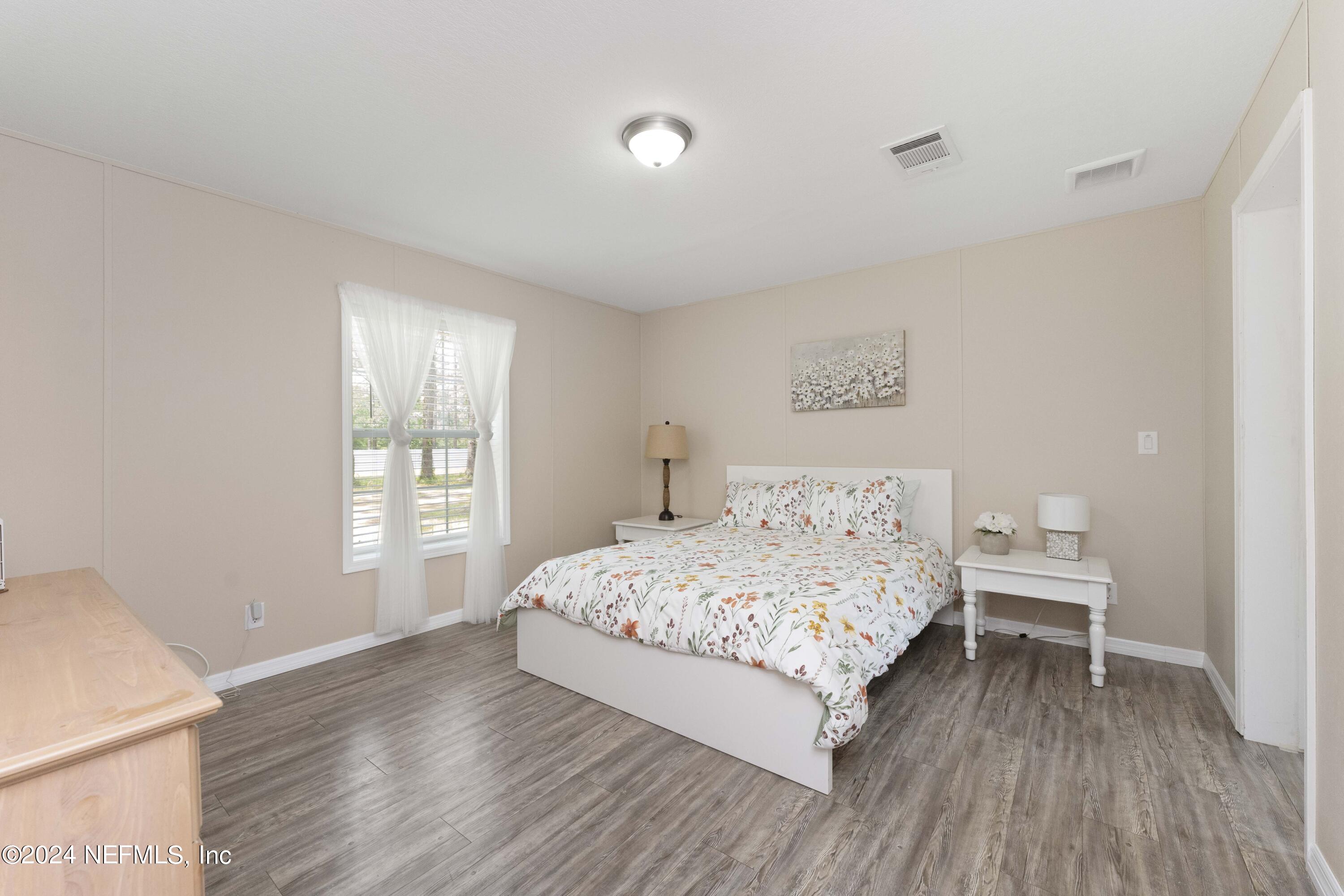 4866 Reed Avenue Jacksonville, FL 32257 - Photo 8 of 25 a bedroom with a bed and a window
