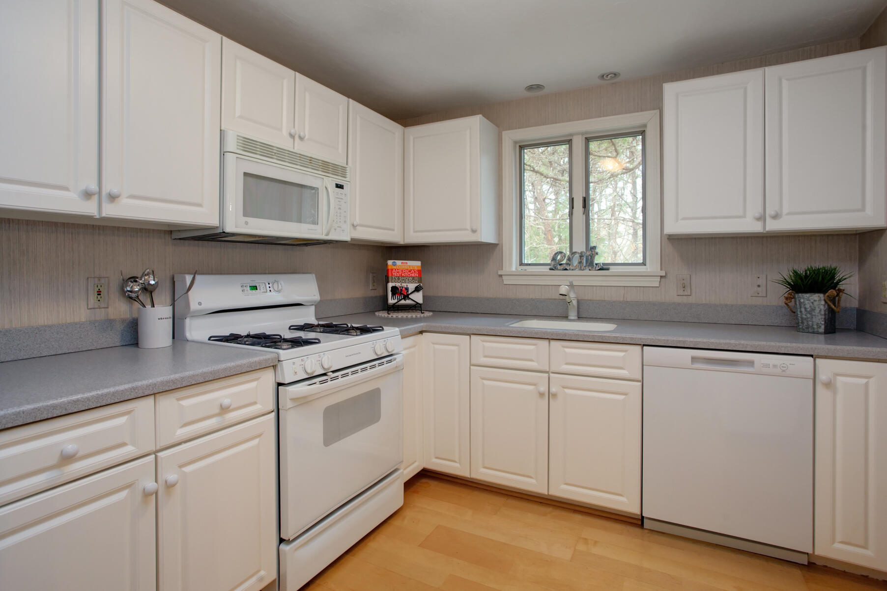 8 Kettle Lane Mashpee, MA 02649 - Photo 13 of 28 a kitchen with white cabinets appliances and a window