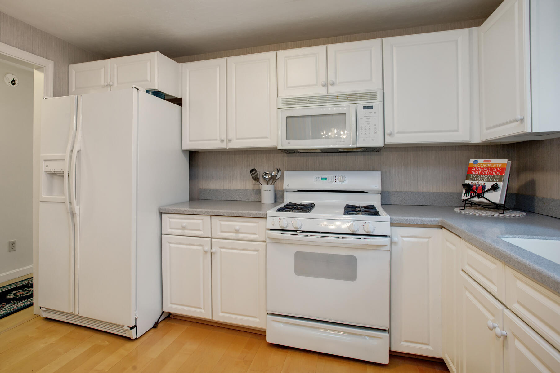 8 Kettle Lane Mashpee, MA 02649 - Photo 14 of 28 a kitchen with white cabinets and white appliances