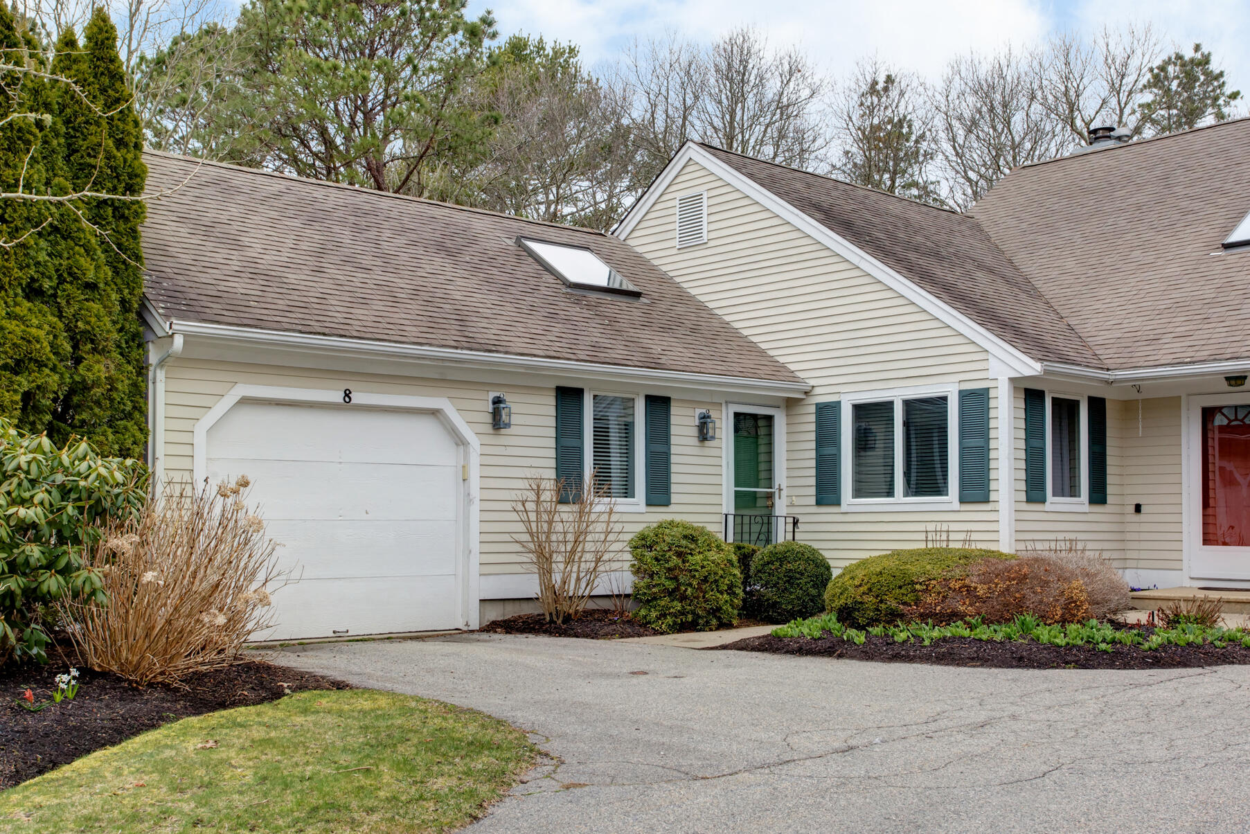 8 Kettle Lane Mashpee, MA 02649 - Photo 3 of 28 a front view of a house with a garden and plants