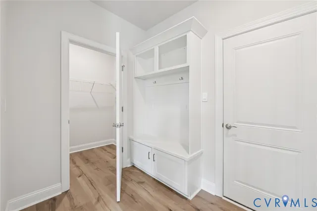 an empty room with ceiling fan and window