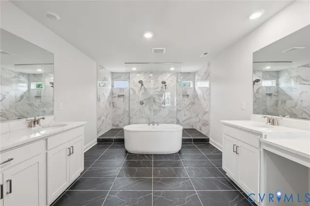 a view of a white house with a big yard and large trees