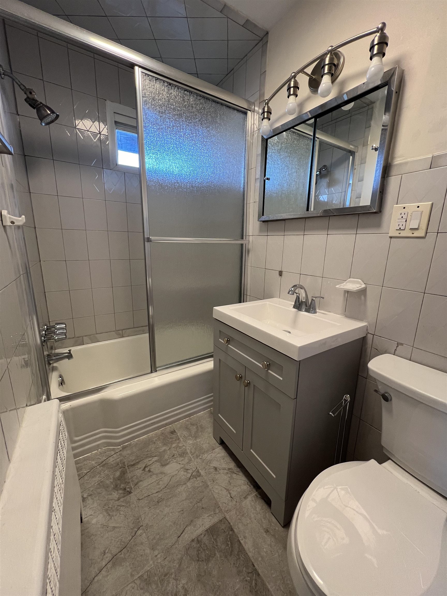618 Broadway, Unit 5 Bayonne, NJ 07002 - Photo 3 of 9 a bathroom with a sink toilet and shower