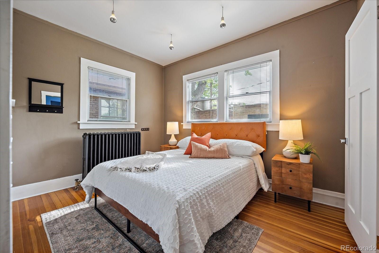 756 Steele Street Denver, CO 80206 - Photo 15 of 32 a bedroom with a bed and a window