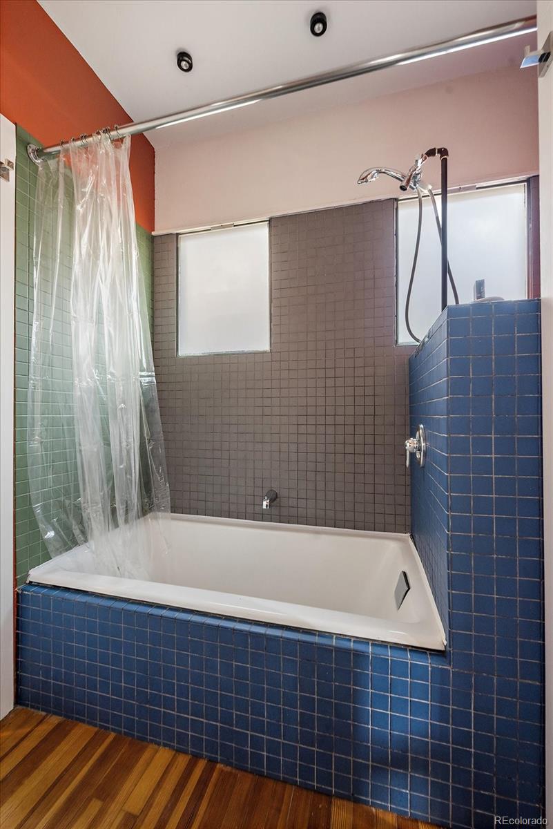 756 Steele Street Denver, CO 80206 - Photo 18 of 32 a bathroom with a bathtub and shower