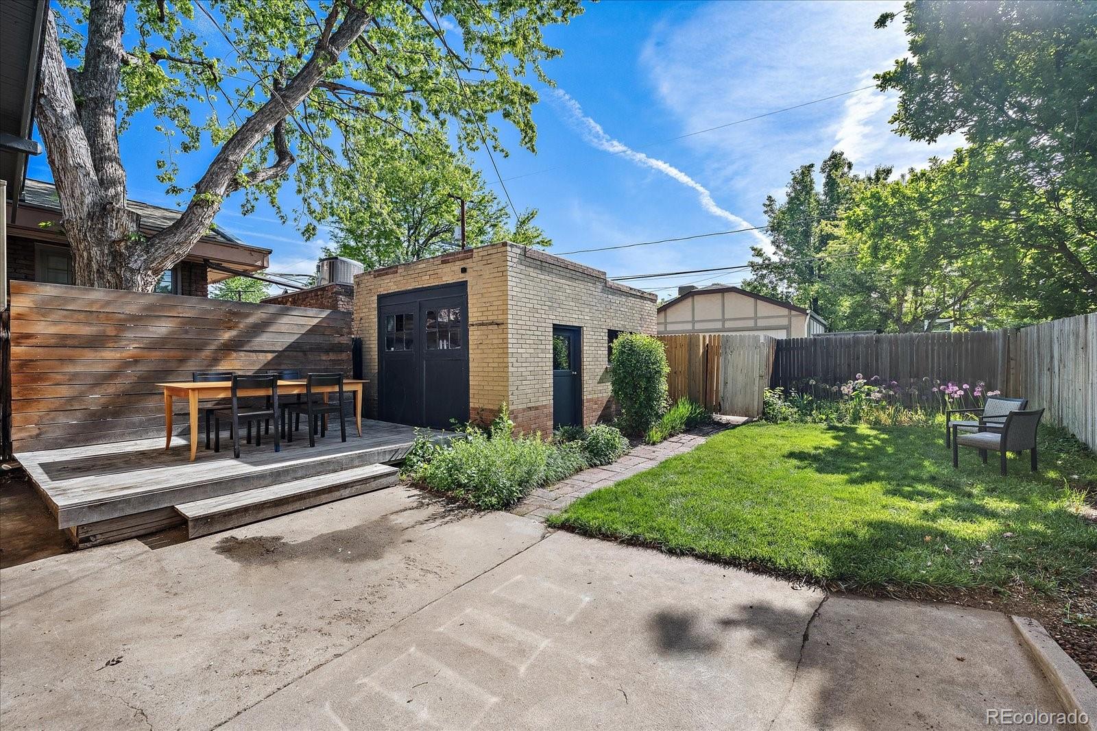 756 Steele Street Denver, CO 80206 - Photo 19 of 32 a front view of a house with garden