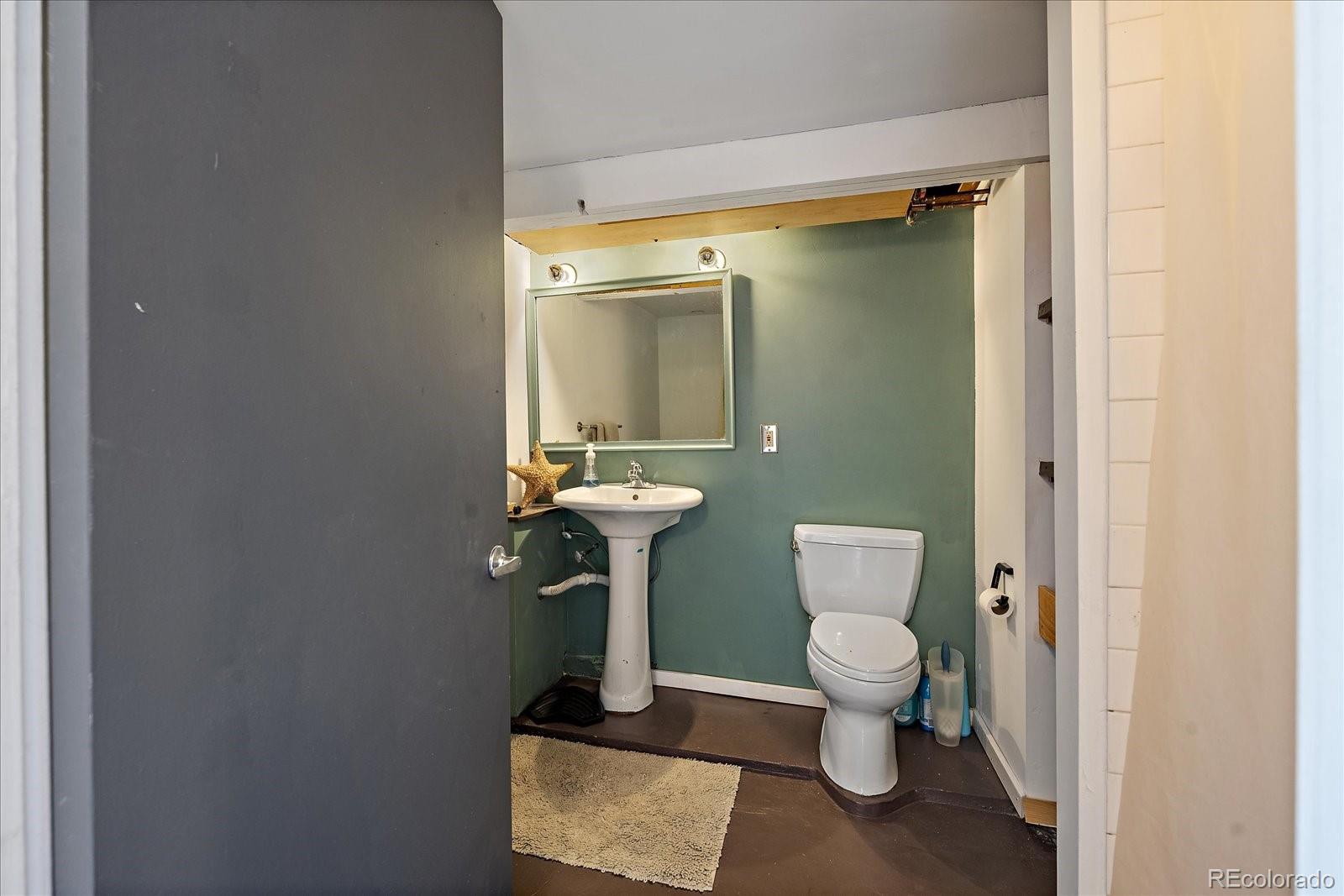 756 Steele Street Denver, CO 80206 - Photo 24 of 32 a bathroom with a toilet and a sink