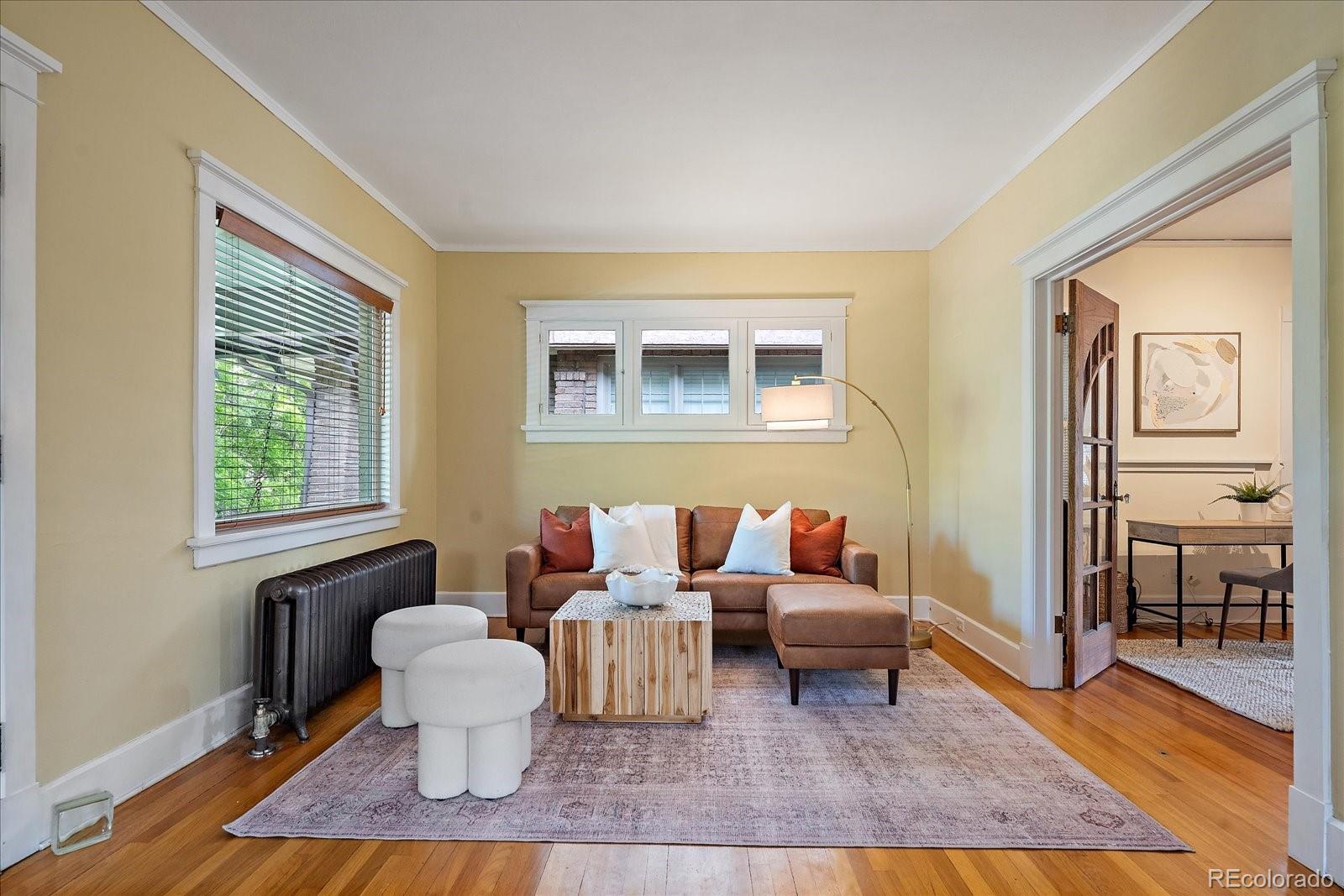 756 Steele Street Denver, CO 80206 - Photo 3 of 32 a living room with furniture and a window