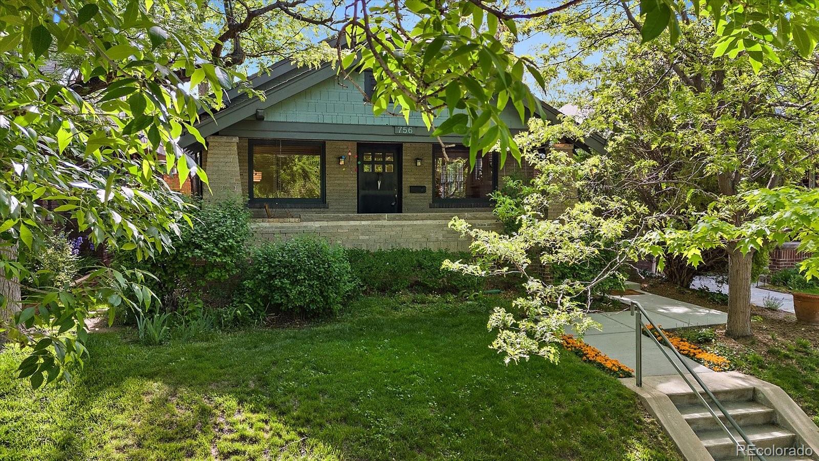 756 Steele Street Denver, CO 80206 - Photo 31 of 32 a front view of a house with garden