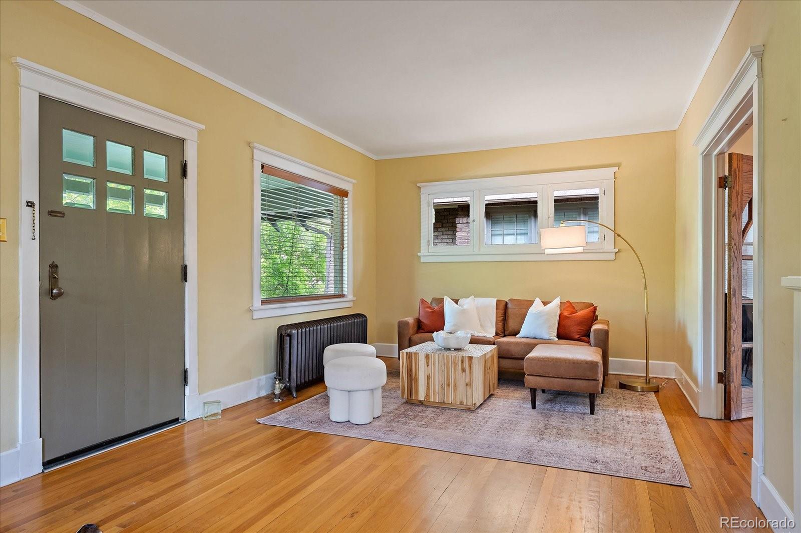 756 Steele Street Denver, CO 80206 - Photo 4 of 32 a living room with furniture and wooden floor