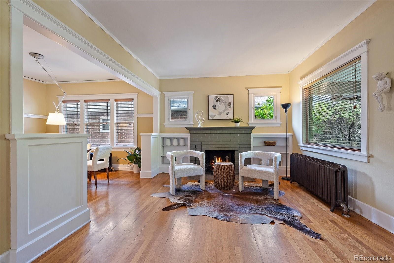 756 Steele Street Denver, CO 80206 - Photo 6 of 32 a living room with furniture a fireplace and a large window