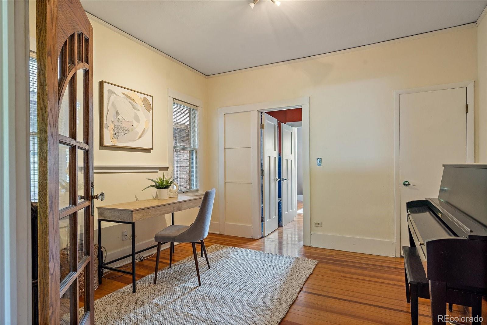 756 Steele Street Denver, CO 80206 - Photo 7 of 32 a view of a workspace with furniture and wooden floor