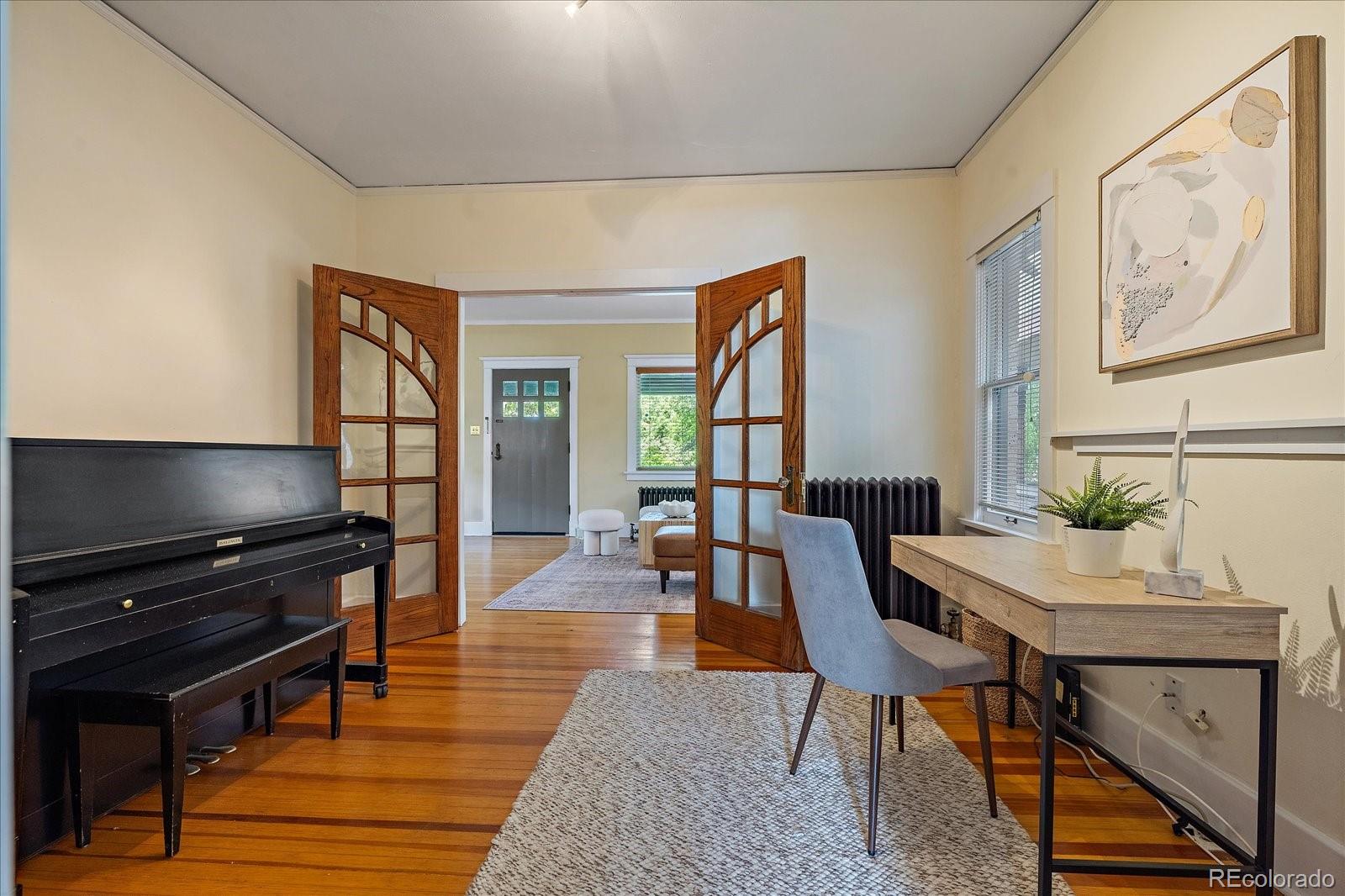 756 Steele Street Denver, CO 80206 - Photo 8 of 32 a dining room with wooden floor and furniture