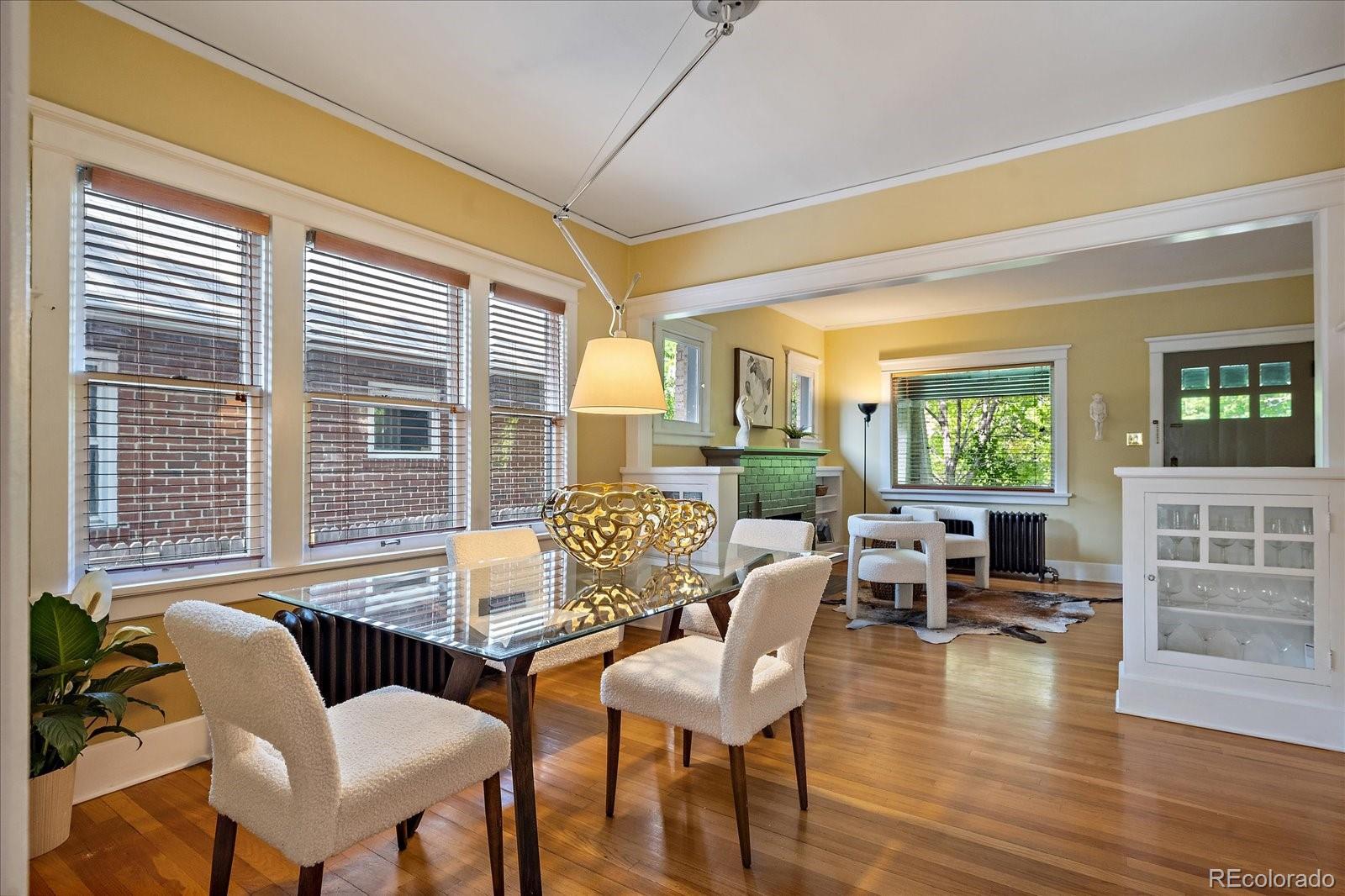 756 Steele Street Denver, CO 80206 - Photo 9 of 32 a view of a dining room with furniture window and wooden floor