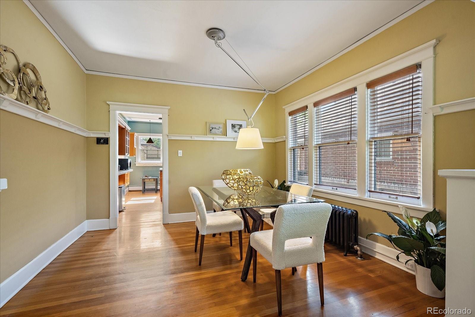 756 Steele Street Denver, CO 80206 - Photo 10 of 32 a view of a dining room with furniture window and wooden floor