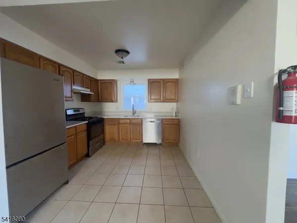 a kitchen with stainless steel appliances granite countertop a refrigerator sink and cabinets