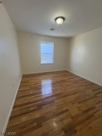 a view of room with wooden floor and window