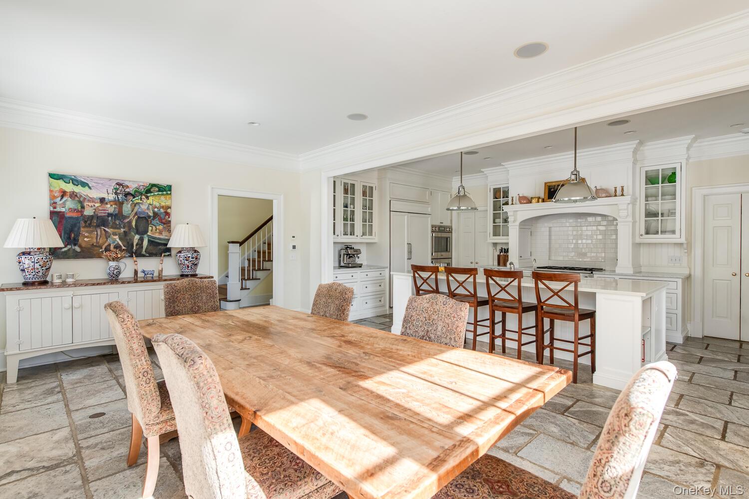 33 Pells Road Rhinebeck, NY 12572 - Photo 13 of 50 Dining area with stone tile flooring, crown molding, and stairway