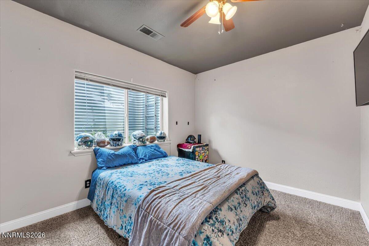 15770 Rocky Vista Road Reno, NV 89521 - Photo 28 of 68 a bedroom with a bed and a chandelier