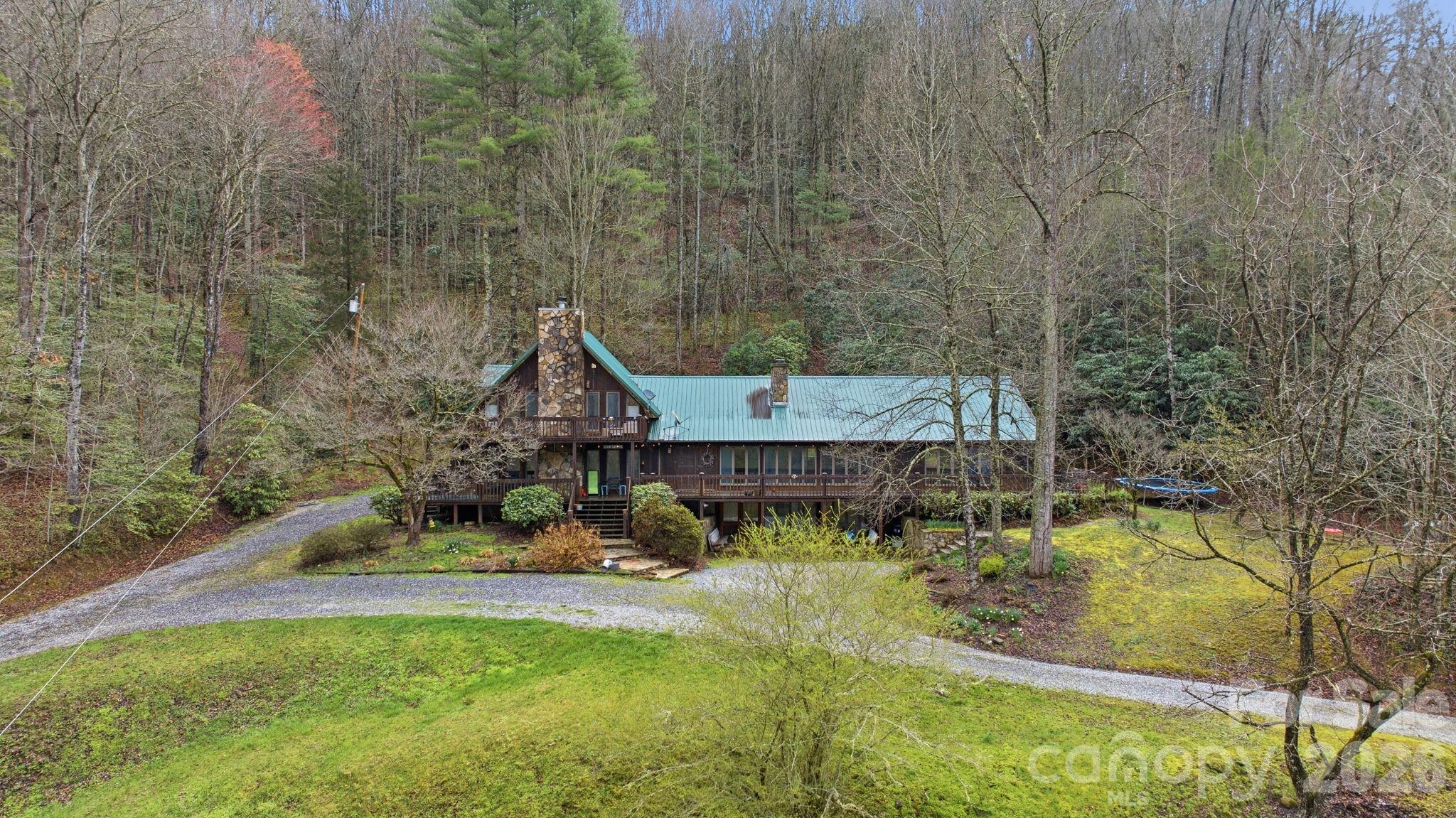 a aerial view of a house with a yard basket ball court and outdoor seating