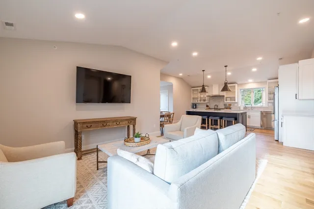 a living room with fireplace furniture and a flat screen tv