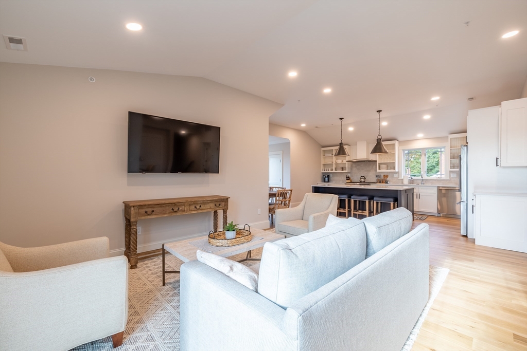 2 Punchard Avenue, Unit 3 Andover, MA 01810 - Photo 11 of 30 a living room with fireplace furniture and a flat screen tv