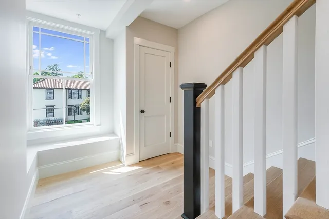 a view of an entryway with wooden floor and staircase