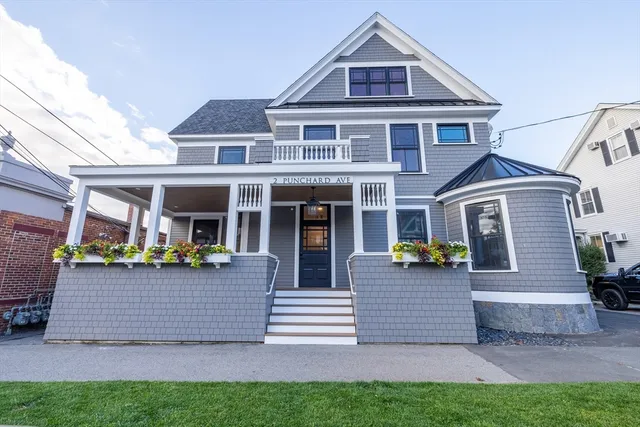 a front view of a house with porch and garden