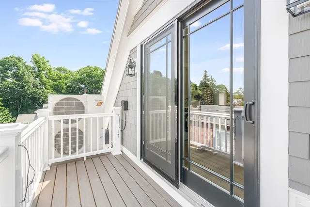 a view of a balcony with wooden floor and fence