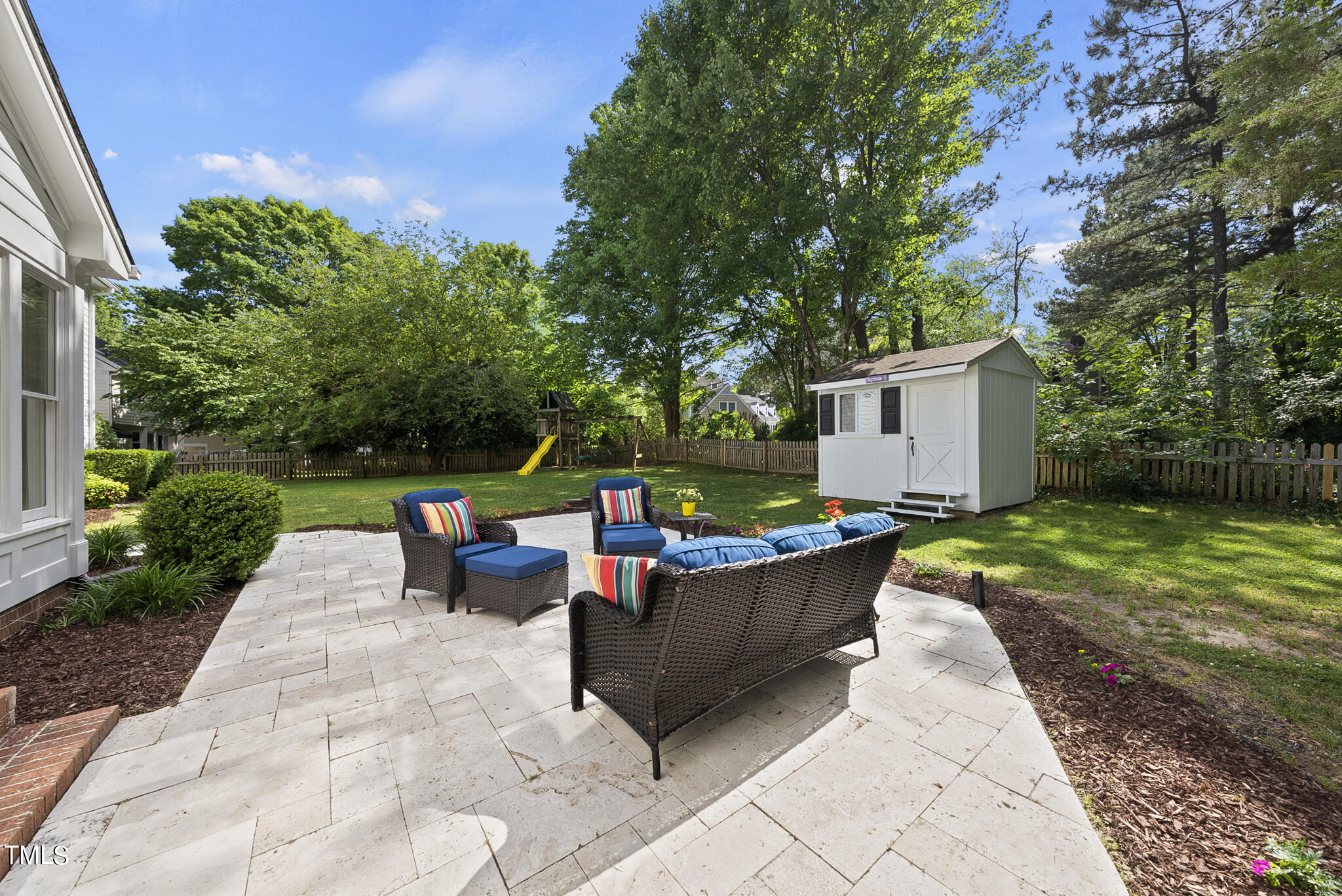 8917 Lindenshire Road Raleigh, NC 27615 - Photo 9 of 36 a backyard of a house with fountain table and chairs