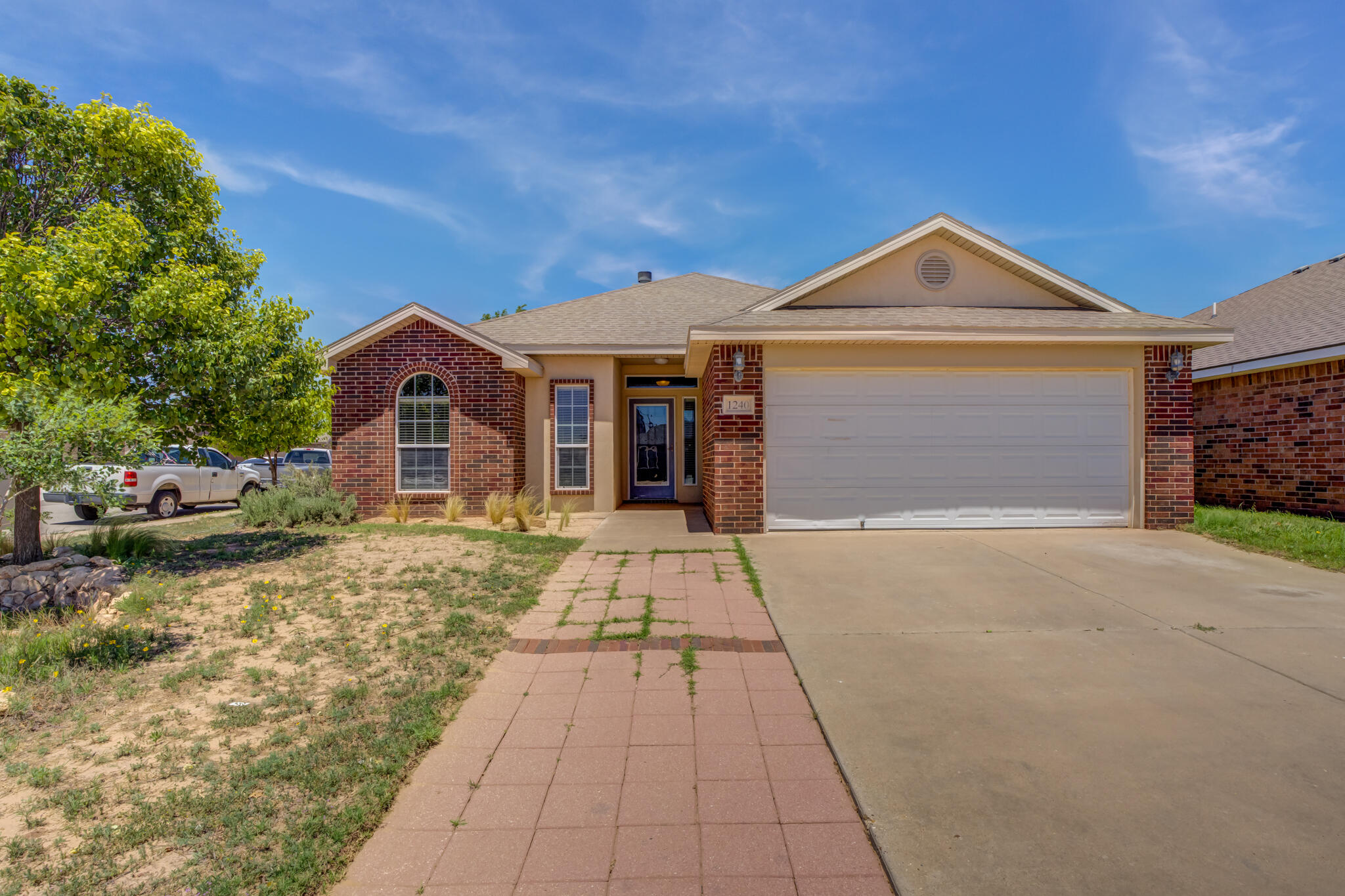 1240 Wheelock Street Lubbock, TX 79403 - Photo 1 of 19 a front view of a house with a yard