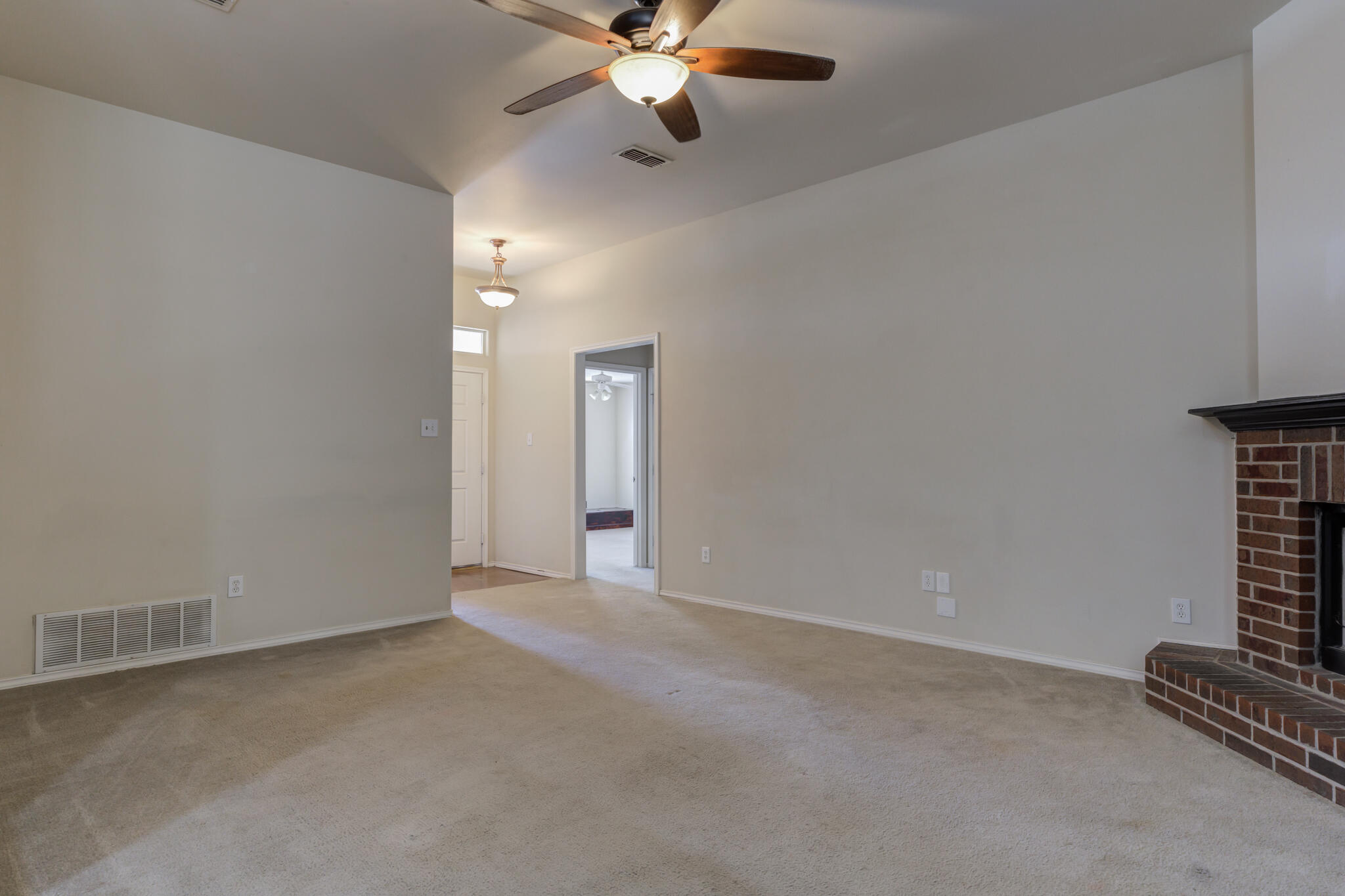1240 Wheelock Street Lubbock, TX 79403 - Photo 5 of 19 an empty room with ceiling fan and window