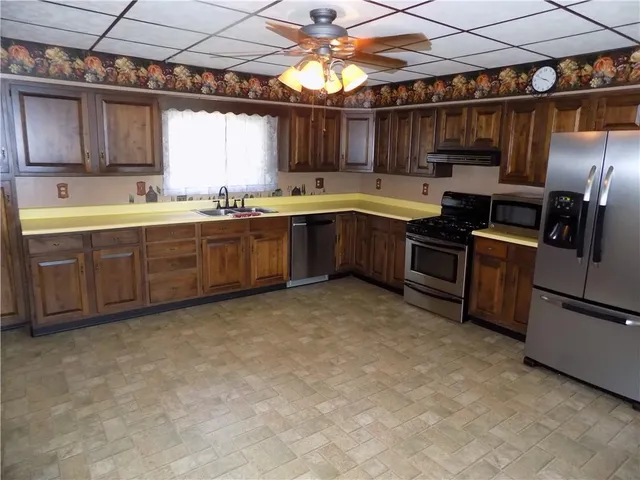 a kitchen with a sink appliances and cabinets