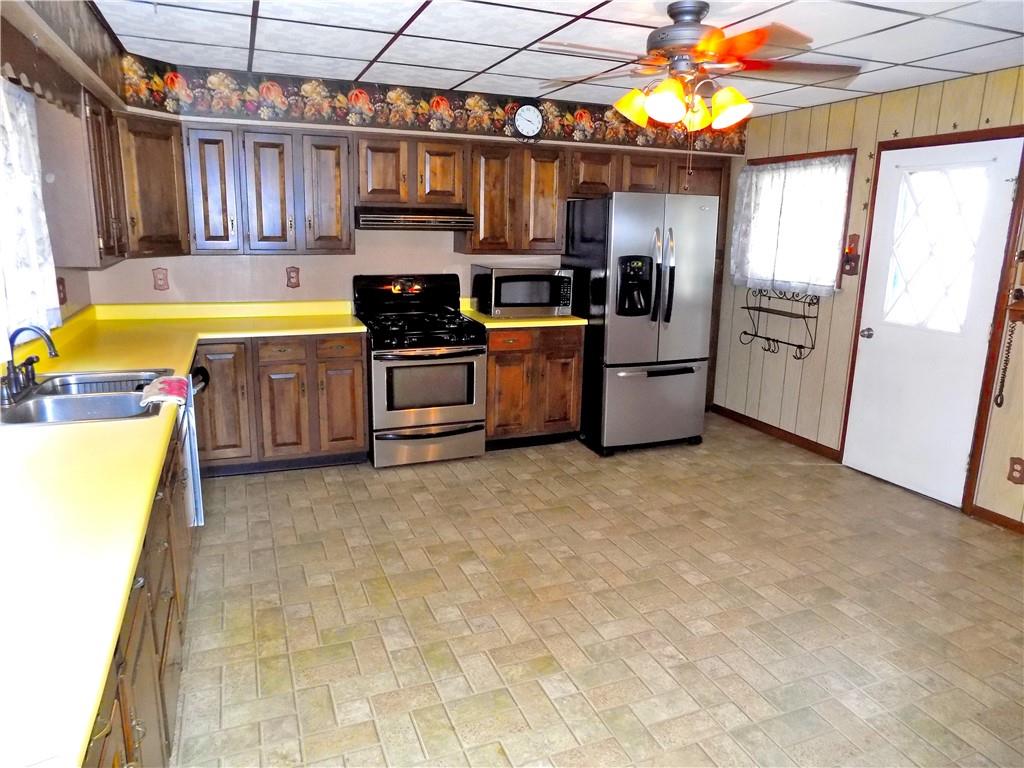 115 Rainey Avenue Uledi, PA 15484 - Photo 6 of 18 a kitchen with a sink appliances and cabinets