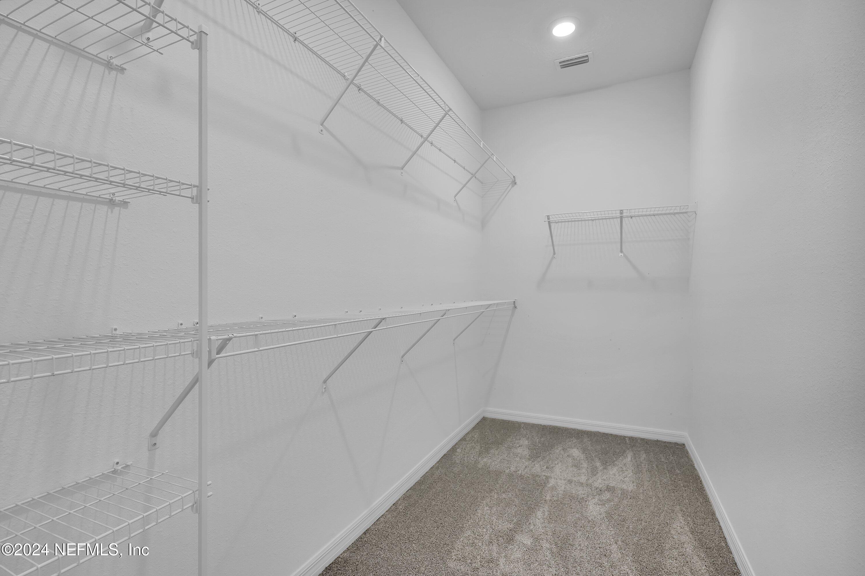 152 Flintlock Lane St. Augustine, FL 32095 - Photo 19 of 40 a view of a room with racks on the wall