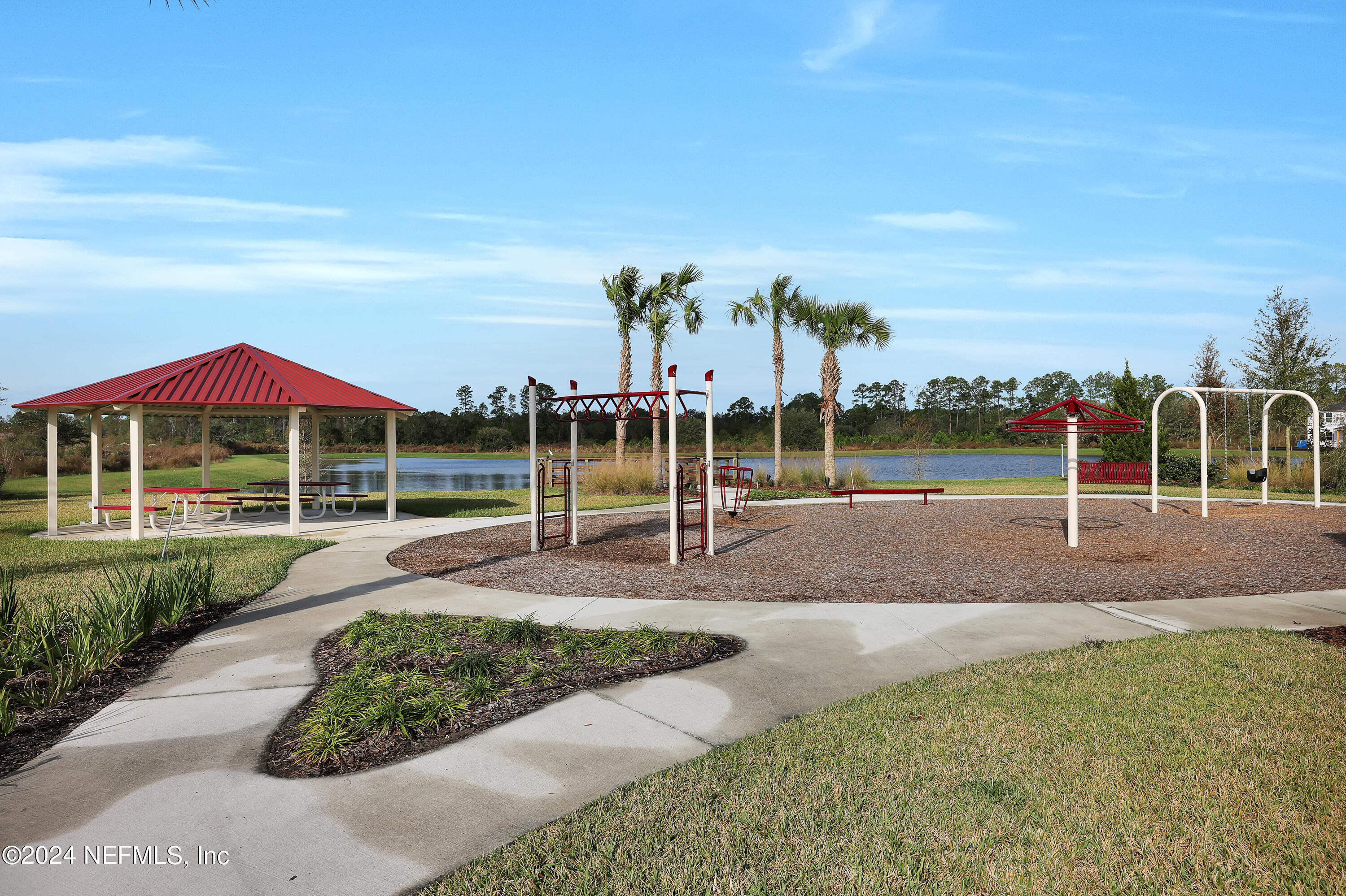 152 Flintlock Lane St. Augustine, FL 32095 - Photo 39 of 40 a view of a park with swings and slides