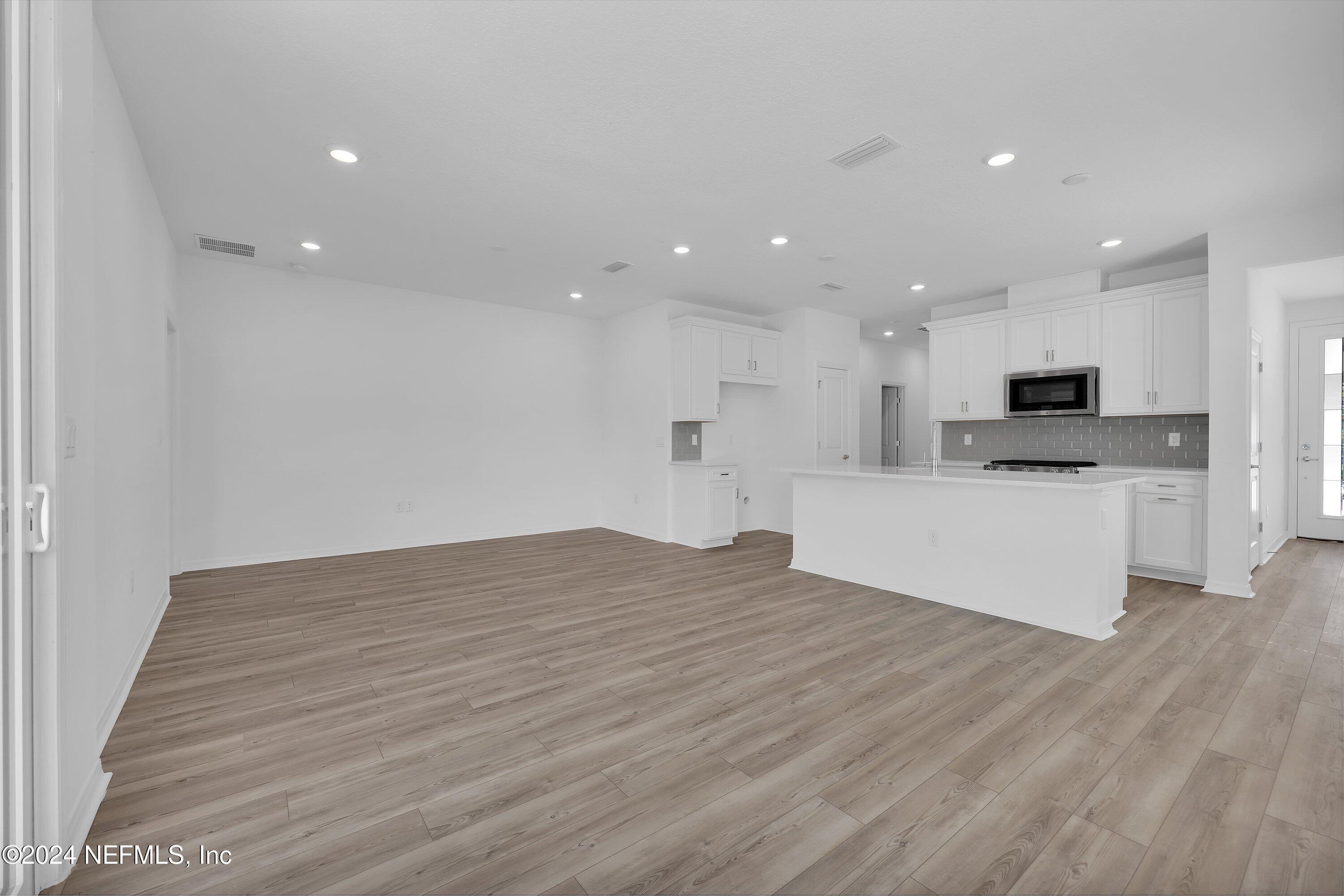 152 Flintlock Lane St. Augustine, FL 32095 - Photo 7 of 40 a view of kitchen with kitchen island sink stainless steel appliances and cabinets