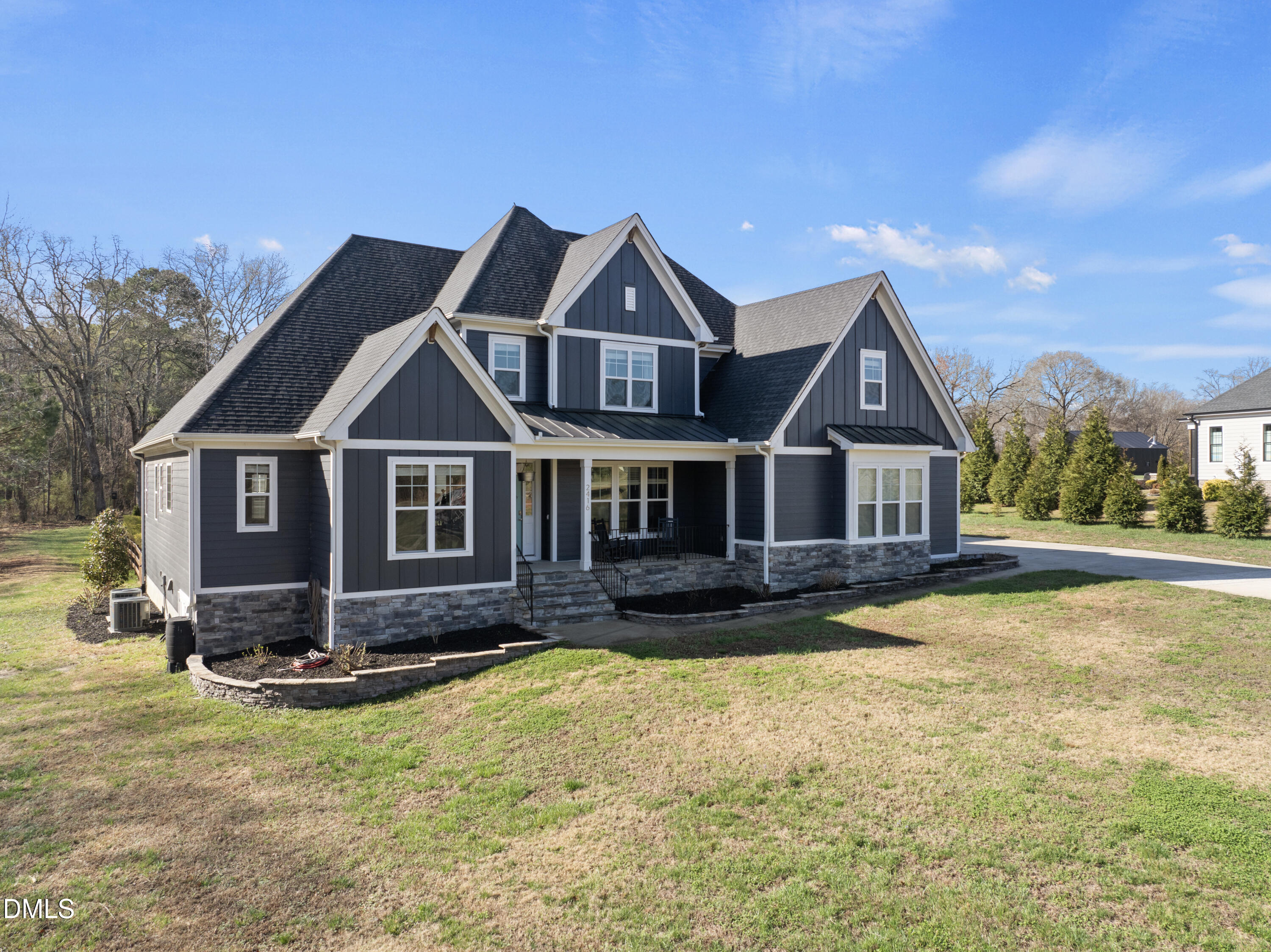 2416 Eddie Howard Road Willow Spring, NC 27592 - Photo 3 of 64 a front view of a house with a yard