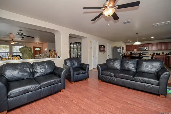 a view of a livingroom with furniture and a ceiling fan