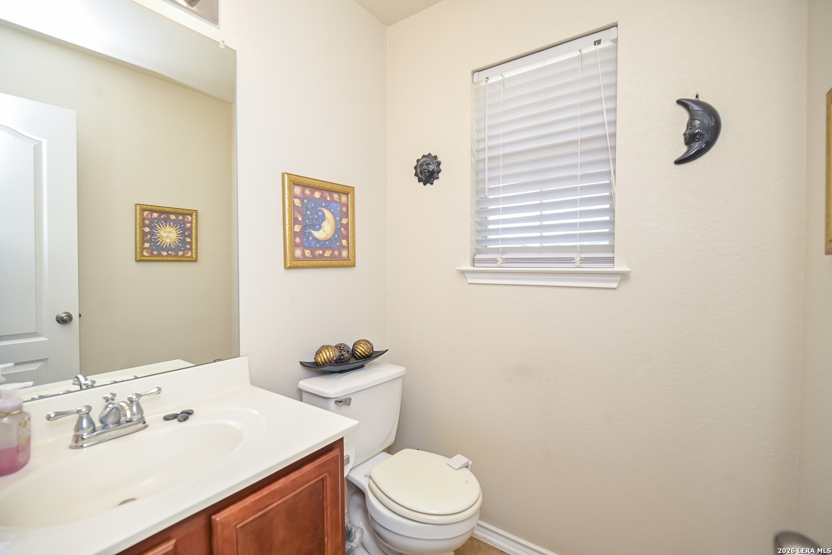 7207 Avery Road Live Oak, TX 78233 - Photo 19 of 42 a bathroom with a sink a toilet and a mirror
